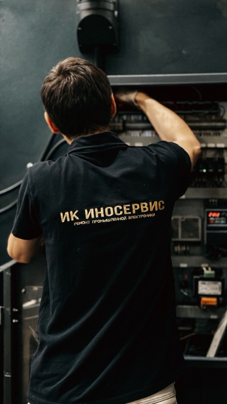 Technician repairing an industrial electrical control panel